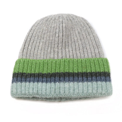 A grey knitted beanie hat with green and blue striped ribbed turn-up
