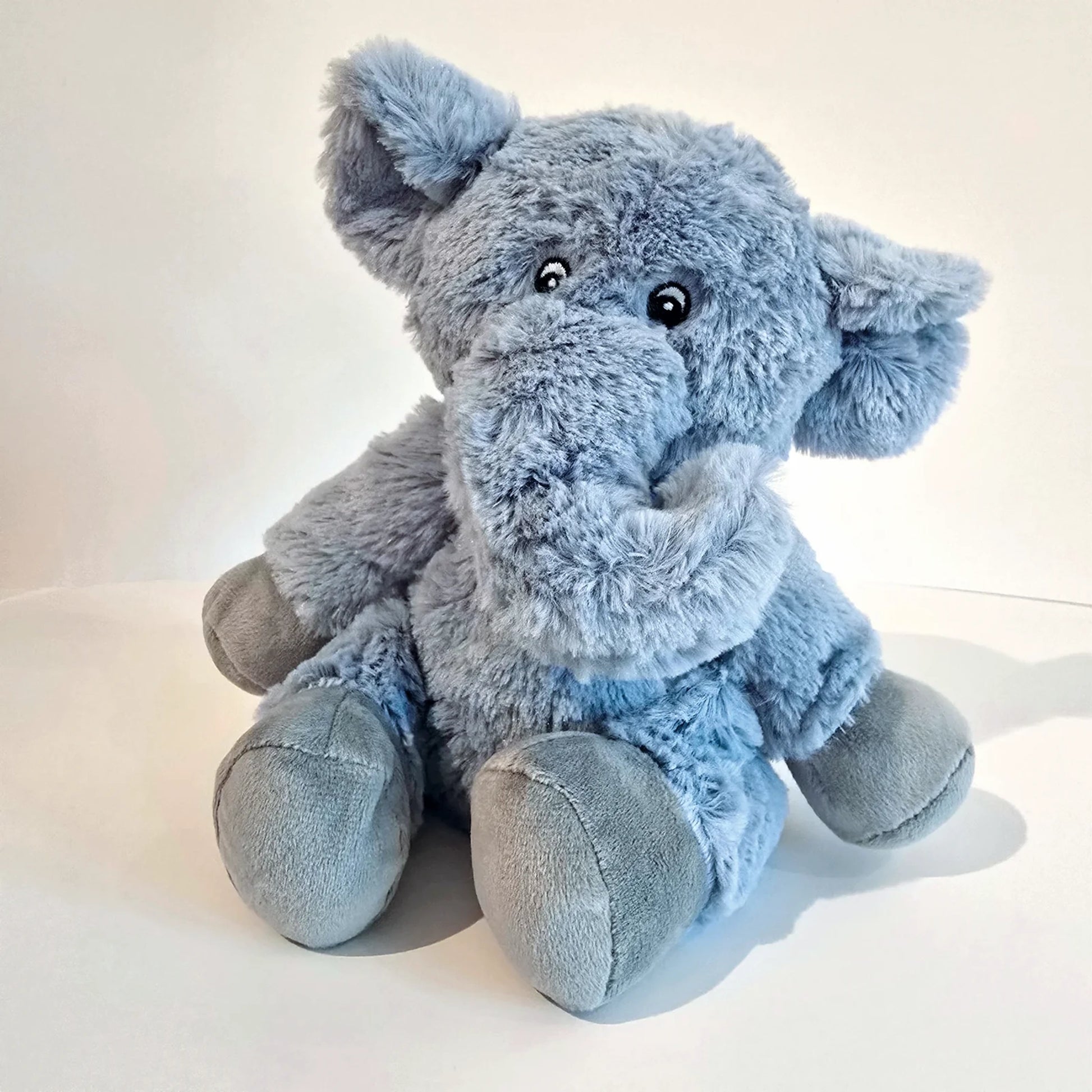 Plush blue elephant toy with microwavable flax-seed head bag insert