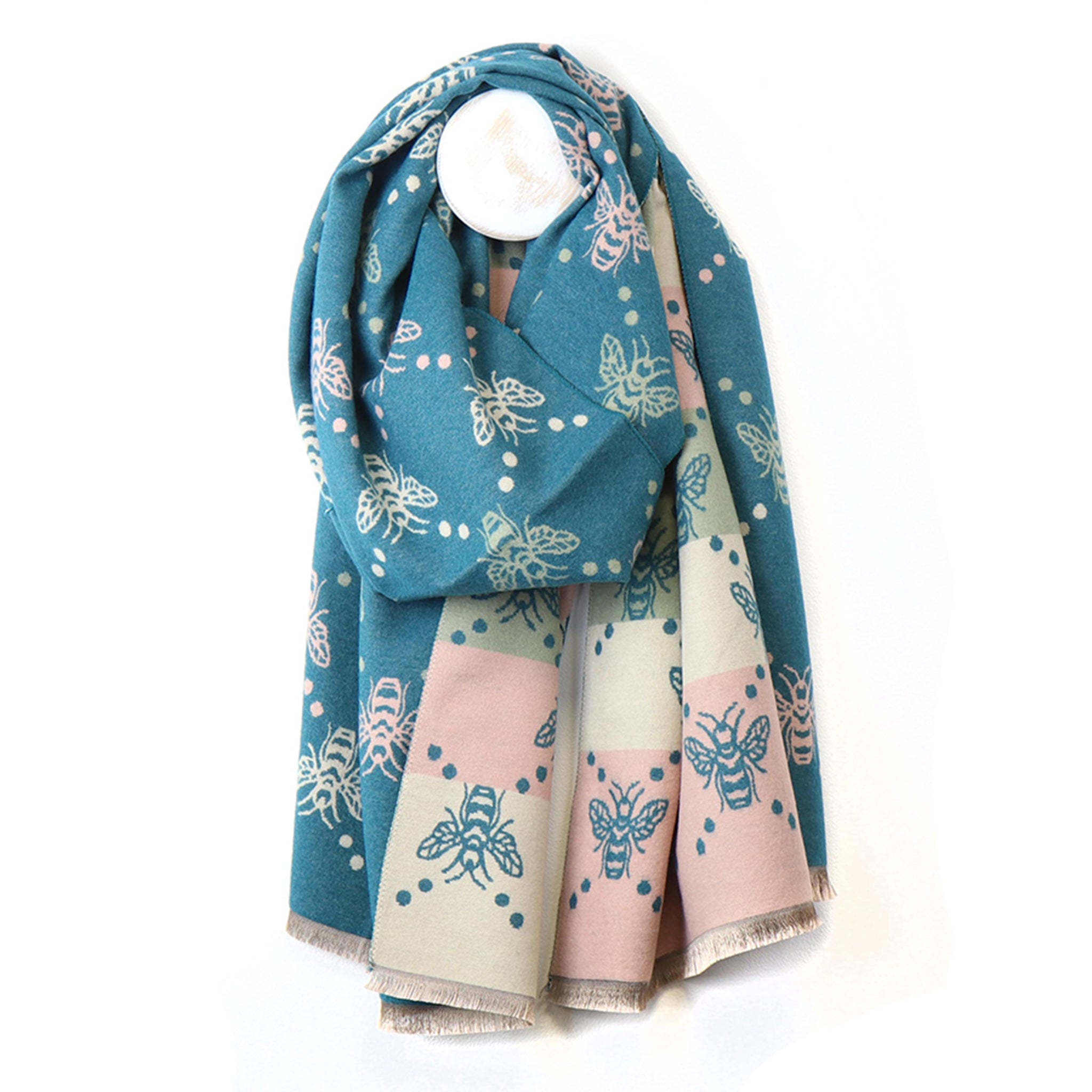 A reversible scarf in teal, pink and cream, with bee pattern