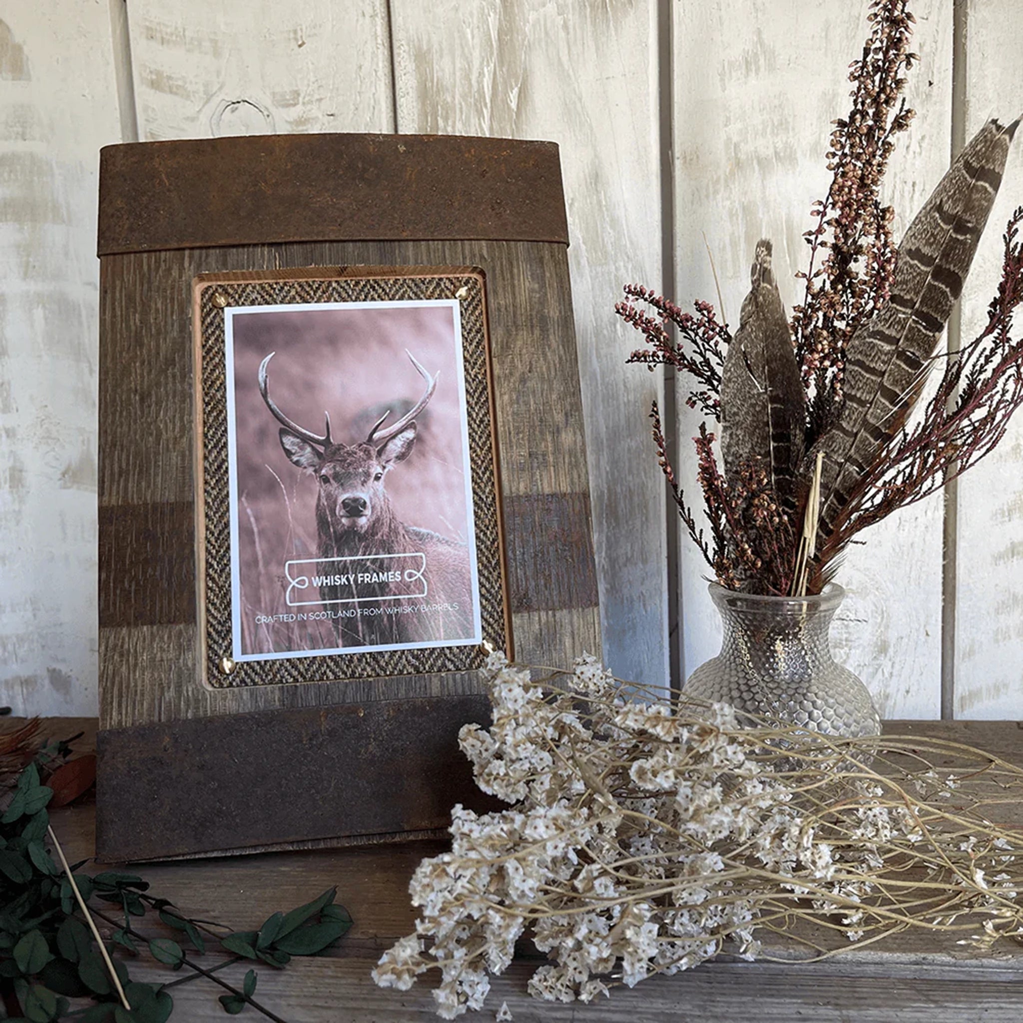 A vertical photo frame with barrel hoop details and Harris Tweed lifestyle