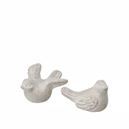 A pair of grey concrete bird figurines, ones with open wings and one with closed wings
