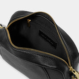 Interior view of black crossbody bag in a simple box shape with adjustable strap and gold hardware