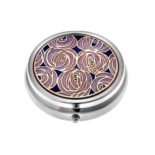 A silver pill box with enamel top featuring a detailed design of Mackintosh roses in purple and gold