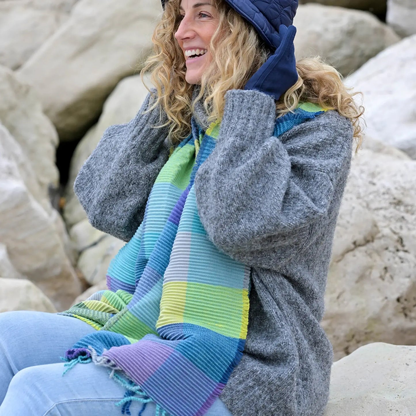 Model wearing colour block scarf in blue, grey, purple and green