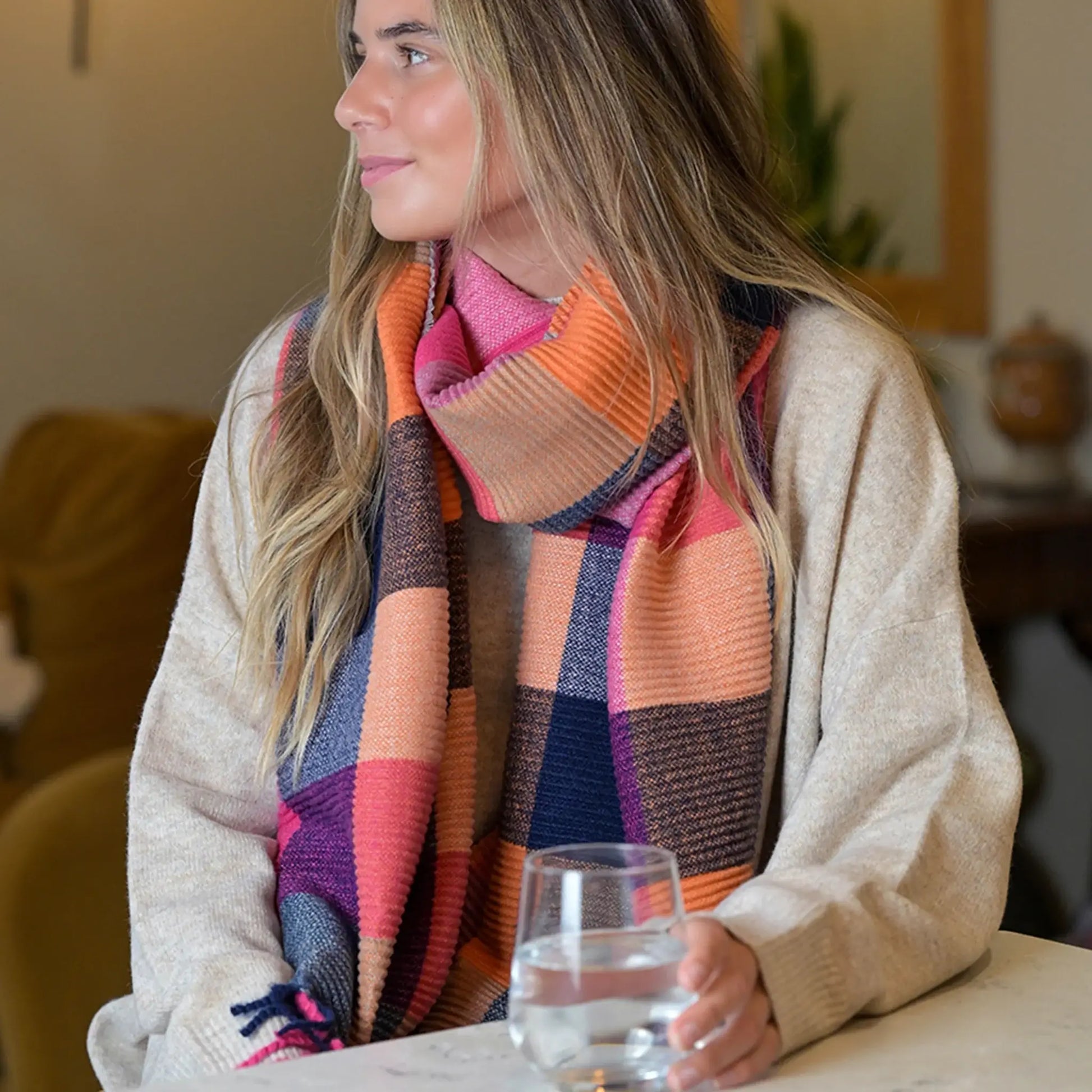 Model wearing colour block scarf in pink, orange and navy 
