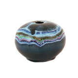 Round organic pebble shaped stoneware bud vase with blue agate stone glaze and small hole in top