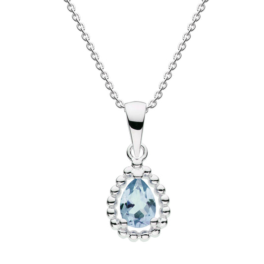 A faceted blue topaz stone teardrop pendant with silver bead surround