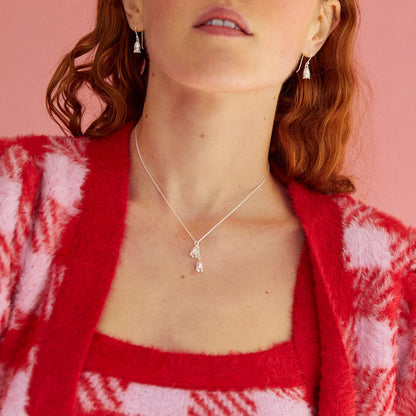 Model wearing satin silver necklace with two bluebell flowers