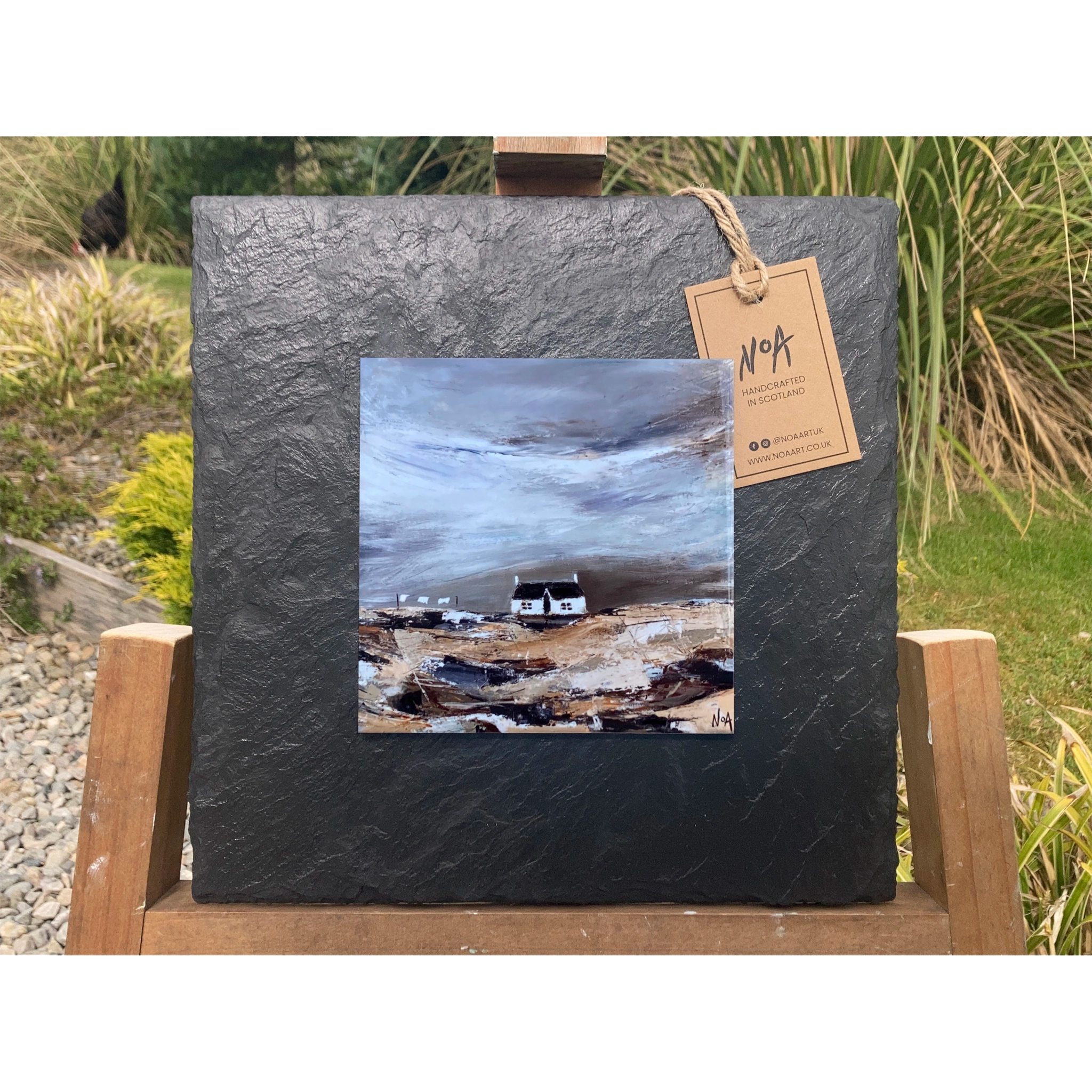 A tile mounted on slate featuring a textured painting of a bothie in the Highlands