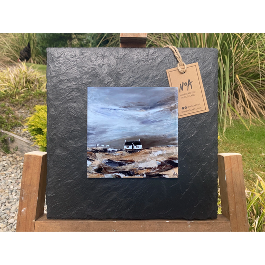 A tile mounted on slate featuring a textured painting of a bothie in the Highlands