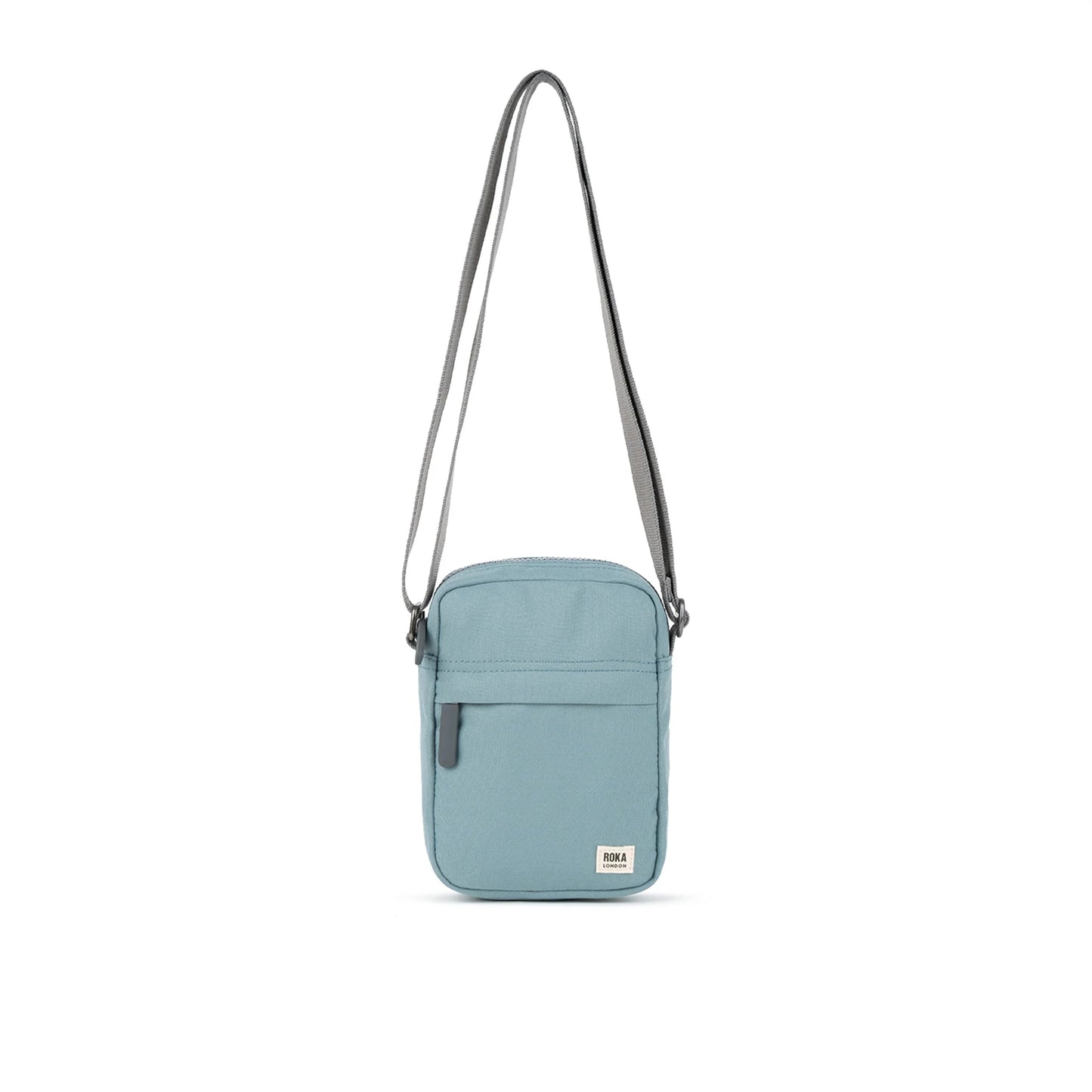 A small crossbody bag in canvas material and a light blue colour