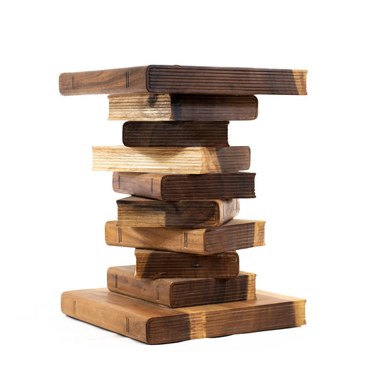 A table in the shape of a stack of book made with a wood blend