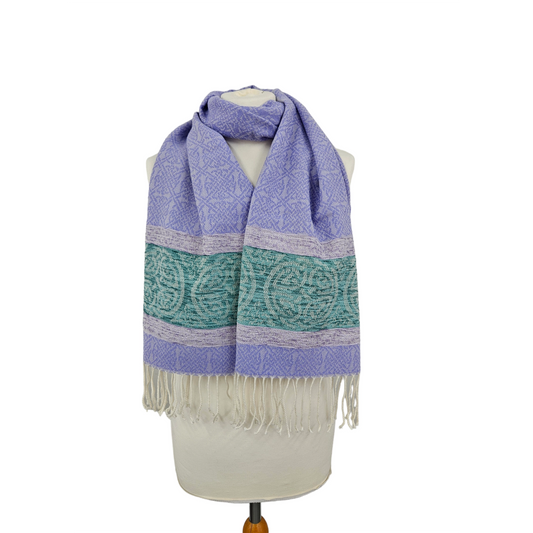 A purple scarf featuring a border of Celtic knots and a tassel trim