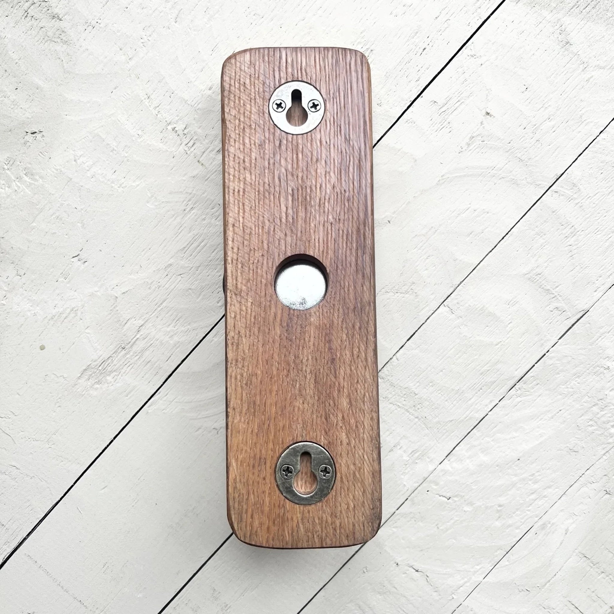 Back of a whisky barrel bottle opener with keyhole wall mount fittings