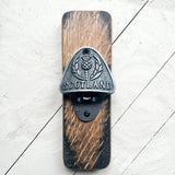 A whisky barrel bottle opener with metal detail featuring thistle and 'Scotland'