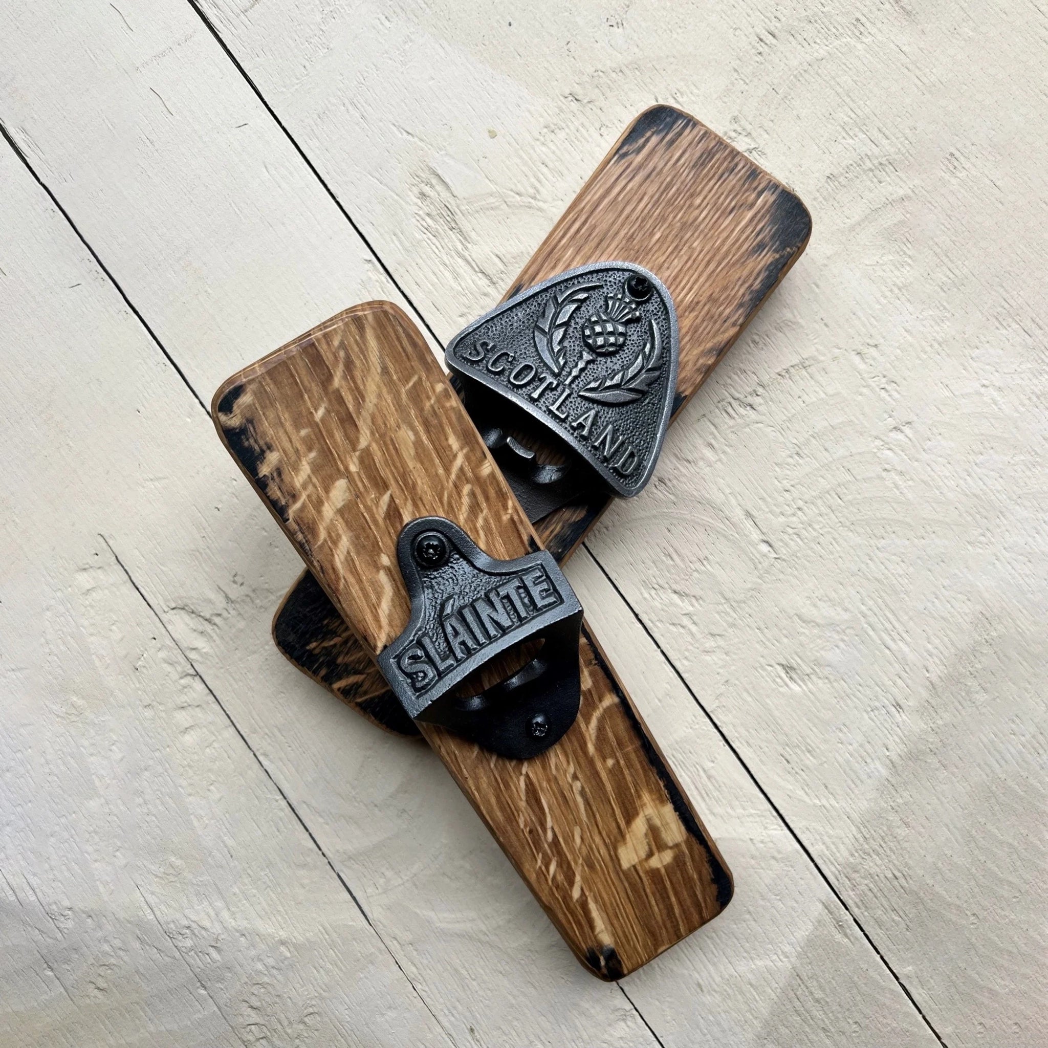 Two whisky barrel bottle openers with metal details