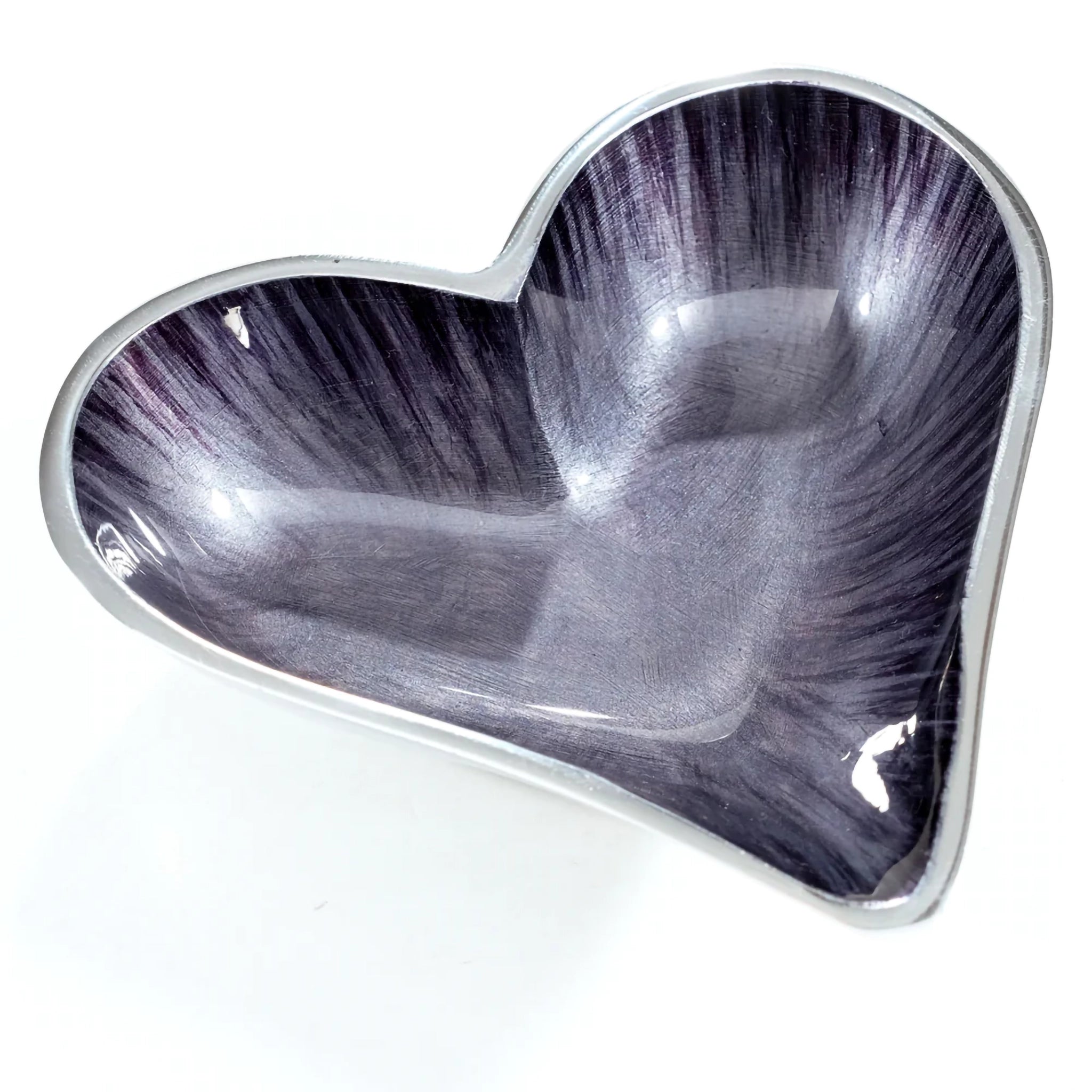 A silver aluminium heart shaped dish with black ombre enamel inside