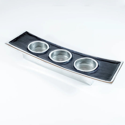 A long rectangular aluminium triple tealight candle holder with  black enamel