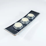 A long rectangular aluminium triple tealight candle holder with black enamel