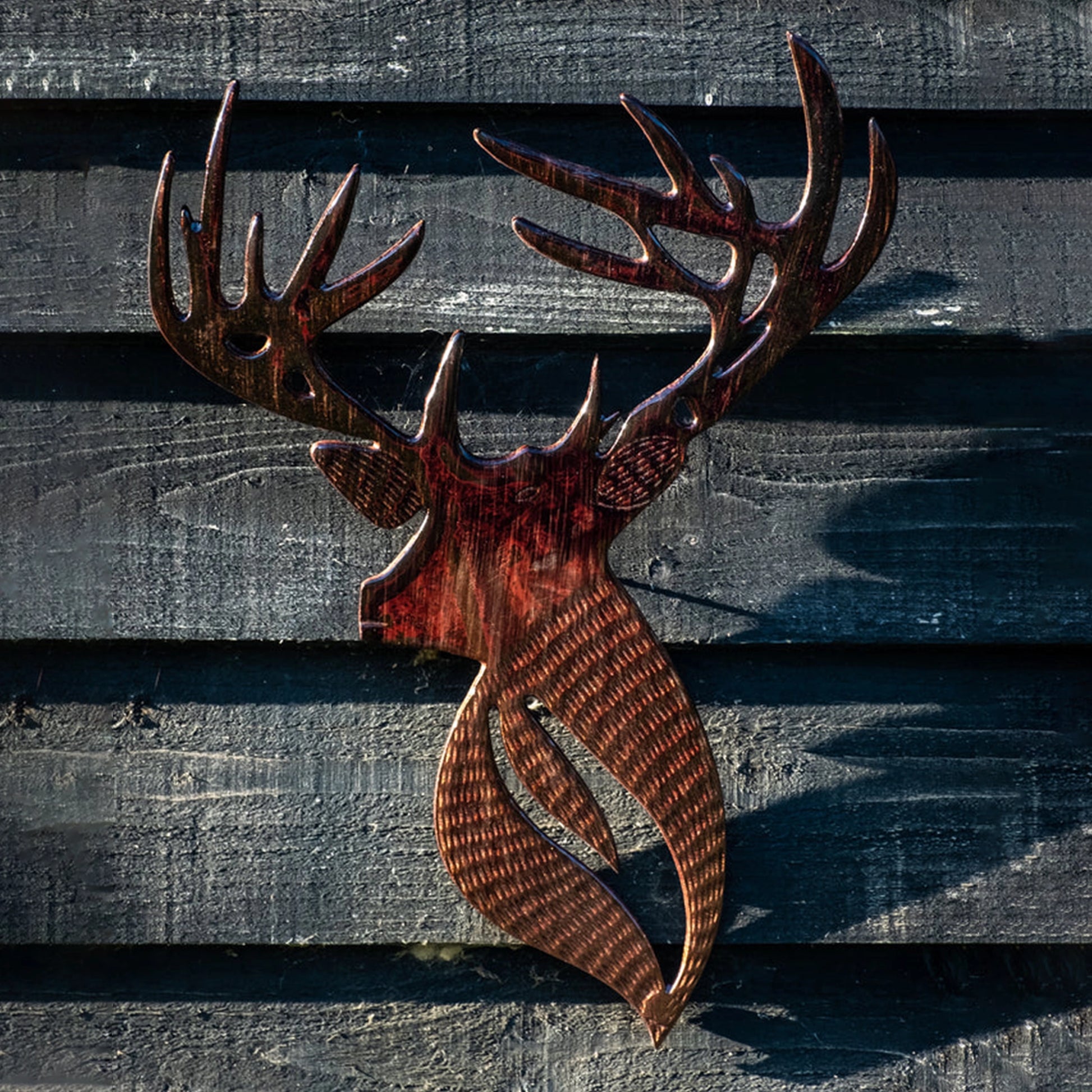 Brown wood look cut out stag wall on outdoor wall