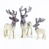 A collection of brushed silver coloured Highland stag sculptures with etched details
