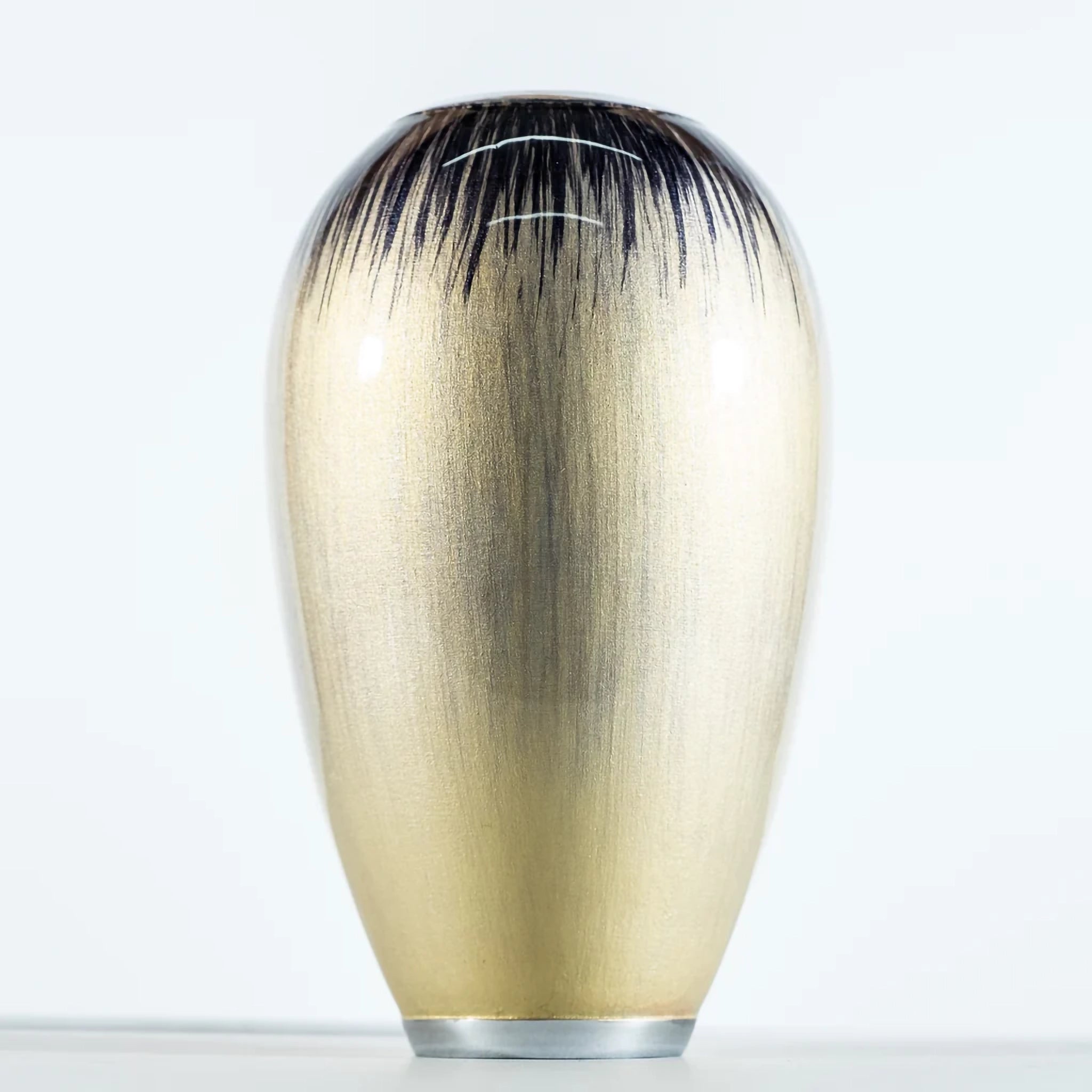 A rounded vase in ombre silver enamel