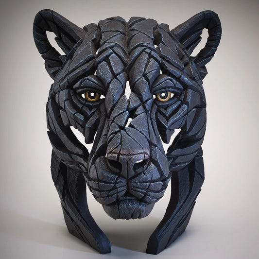 Front view of a modern sculpture of a black panther bust with brown eyes