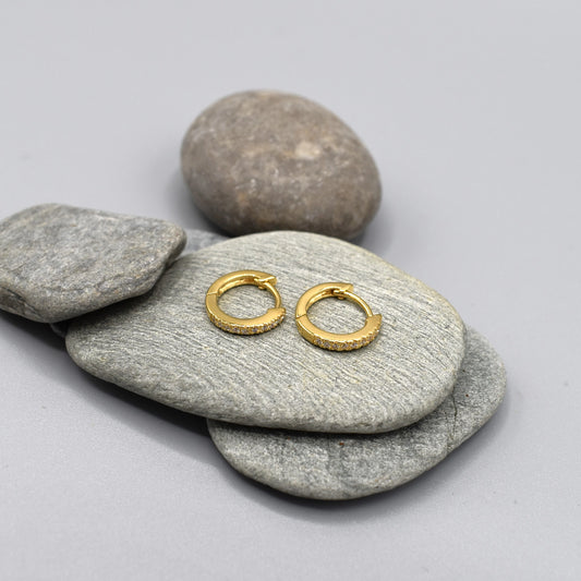 A pair of CZ set yellow gold huggie hoop earrings