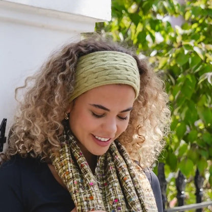 Model wearing a cable knitted blue headband