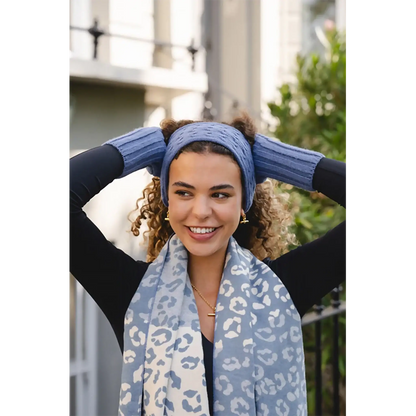Model wearing a cable knitted blue headband