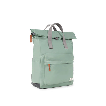 Mint green rolltop backpack with grey grab handles side view