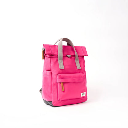 Bright pink hiking roll top backpack with grey handle side