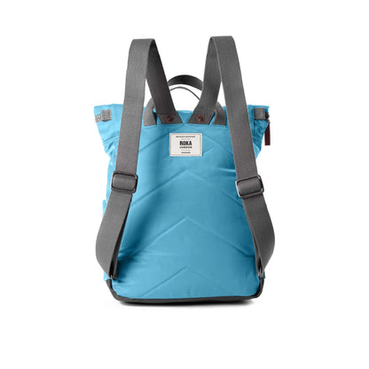 Light blue rolltop backpack with grey adjustable shoulder backpack handles