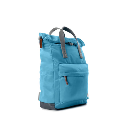 Light blue rolltop backpack with grey grab handles side view