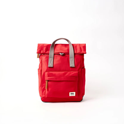 Bright red hiking roll top backpack with grey handle