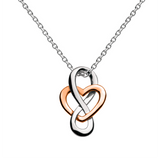 A silver pendant with a rose gold heart shape