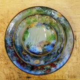 Stack of three glazed stoneware dishes, each featuring hand painted design of a rock pool bottom