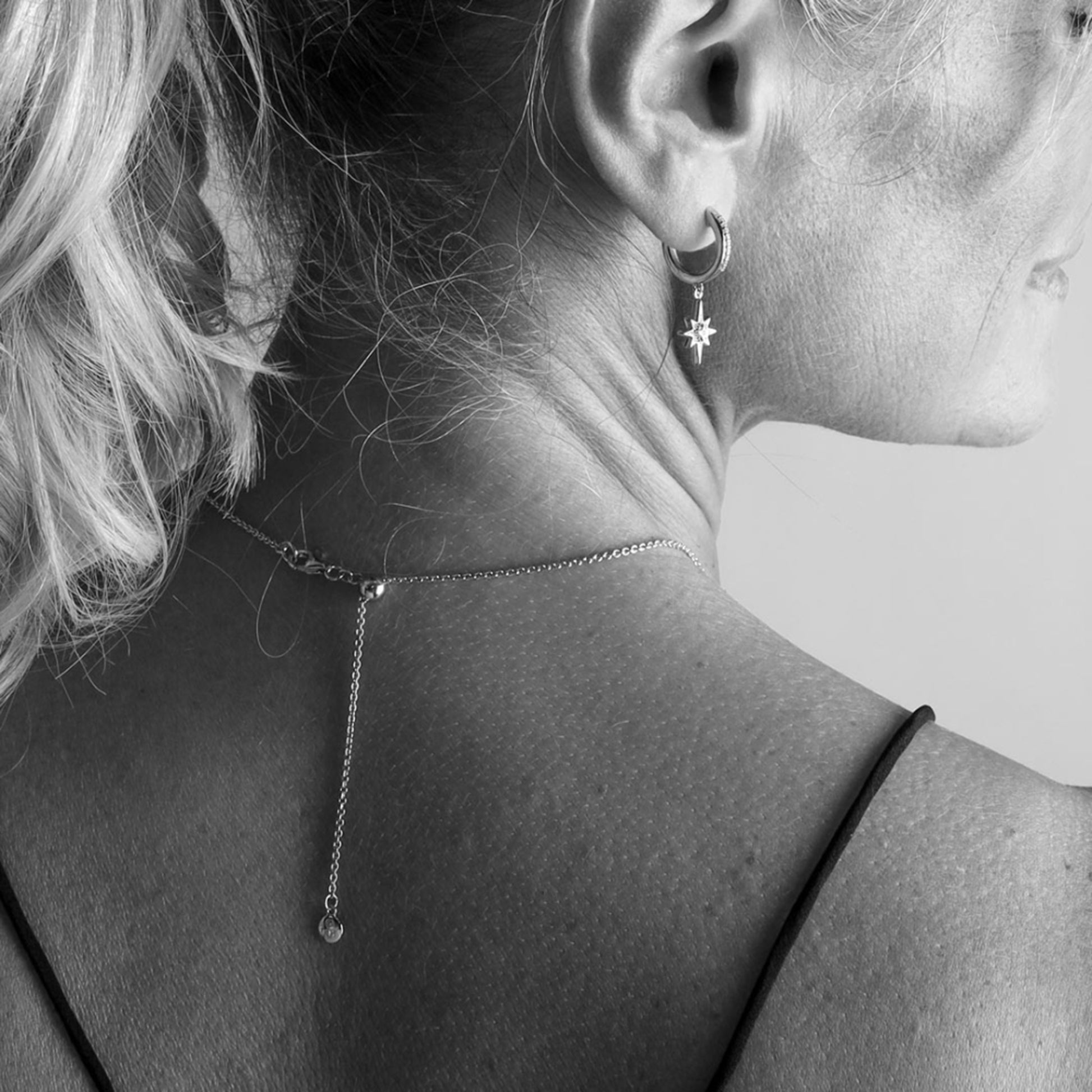 Model wearing silver chain with slider toggle catch