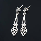 Pair of long teardrop shaped Celtic knot style silver drop earrings with stud backings