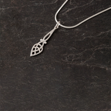 A long teardrop shaped Celtic knot style silver pendant with silver snake chain
