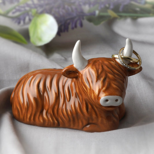 A ceramic Highland Cow shaped ring holder lifestyle