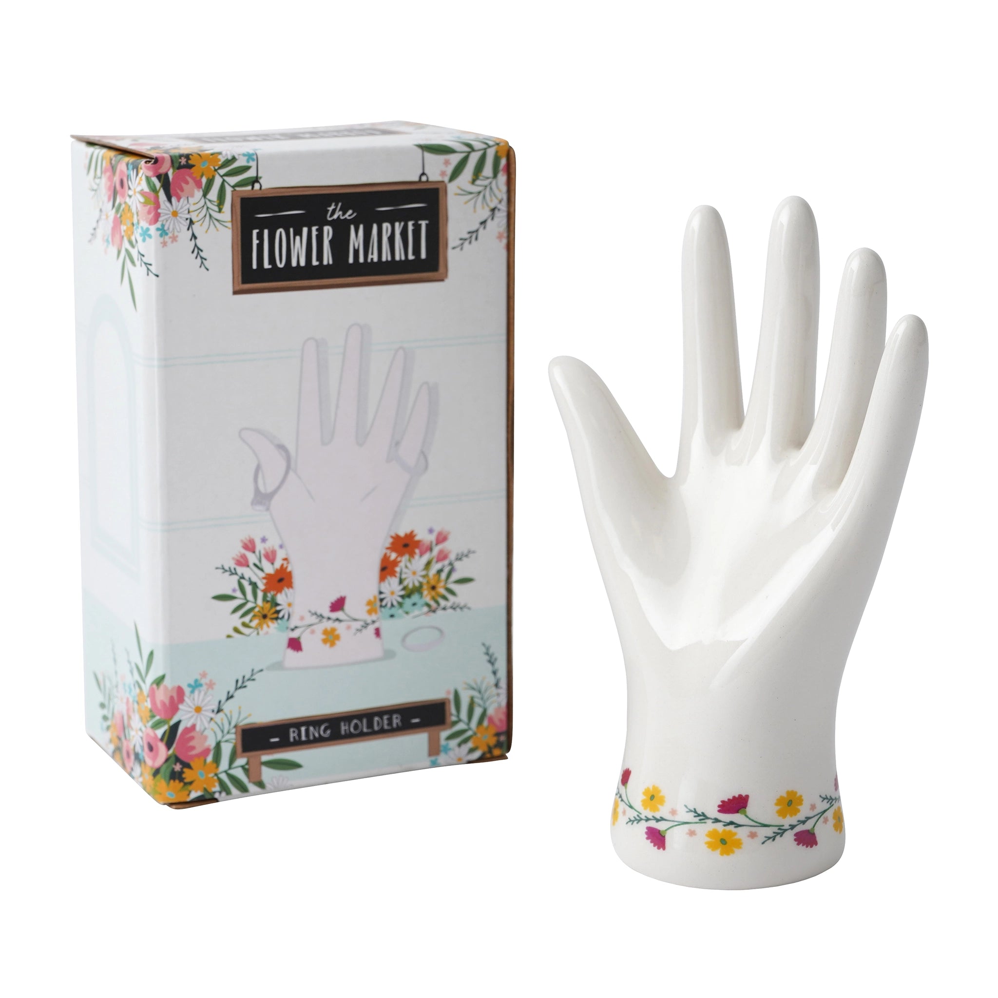 A ceramic white hand shaped ring holder with floral design