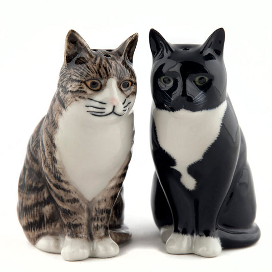 Pair of glazed ceramic salt and pepper shakers in the shape of sitting cats, one black and white and one tabby and white