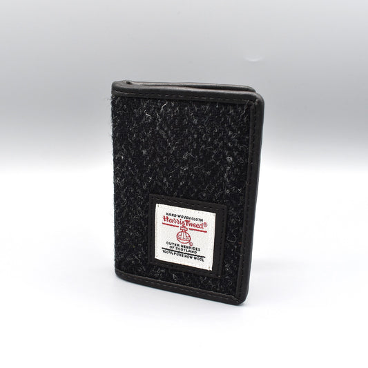 A fold over card holder featuring a charcoal coloured Harris tweed front 