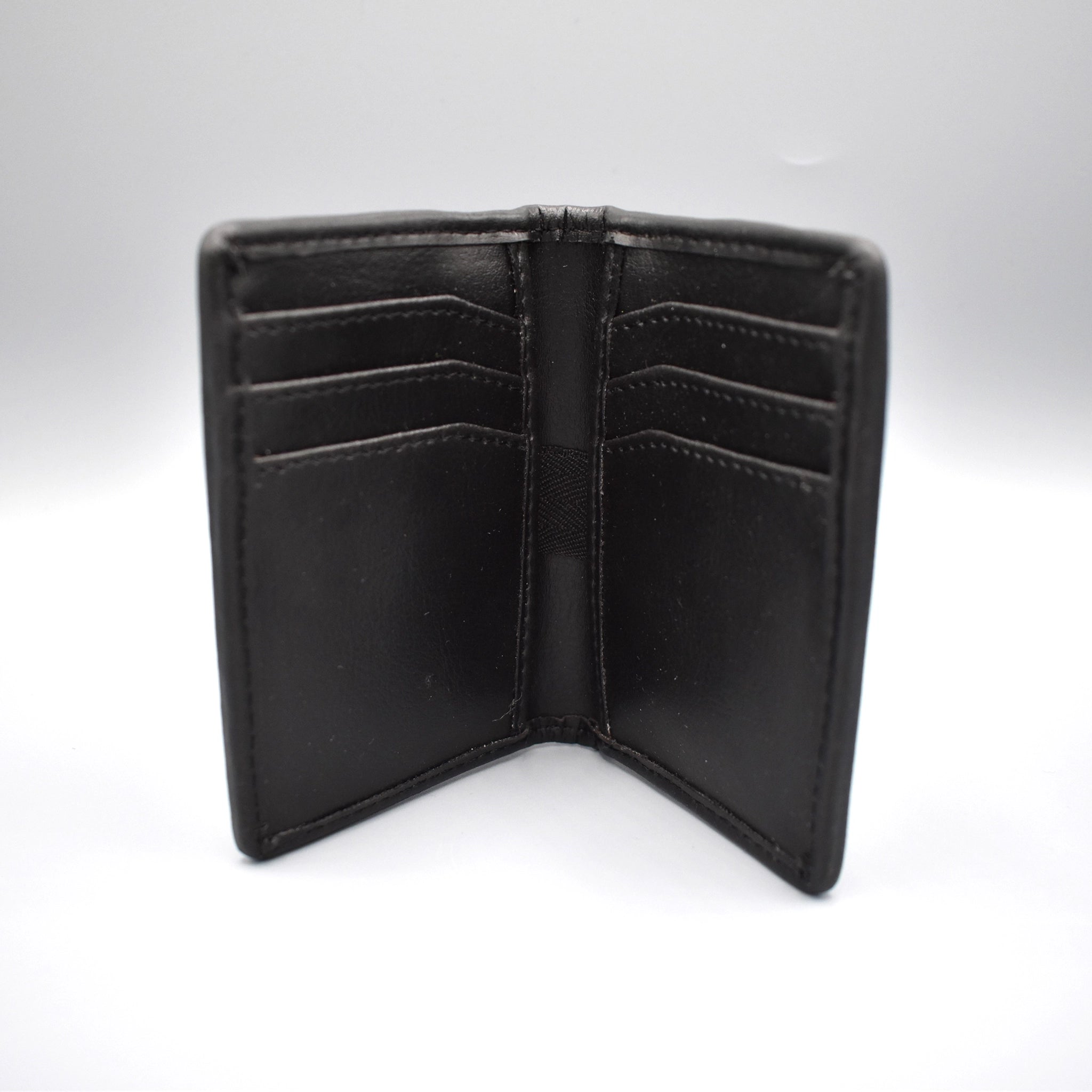 Inside of a charcoal faux leather card holder with 8 card slots