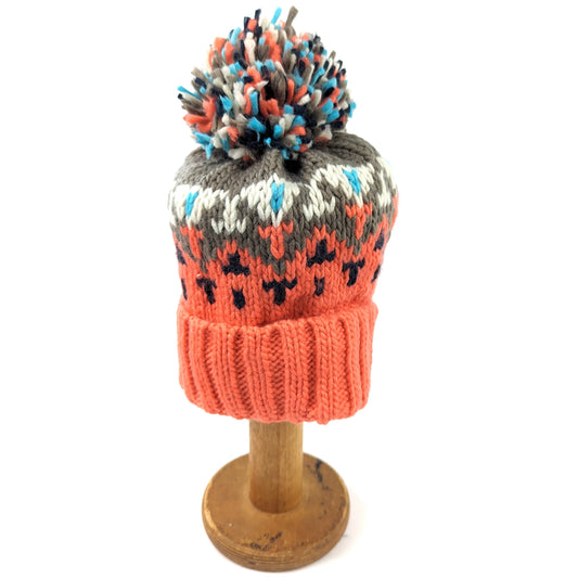 Chevron knitted hat with cream, grey and orange geometric design and pompom