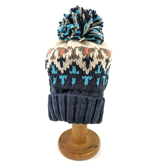 Chevron knitted hat with navy, cream and light blue geometric design and pompom
