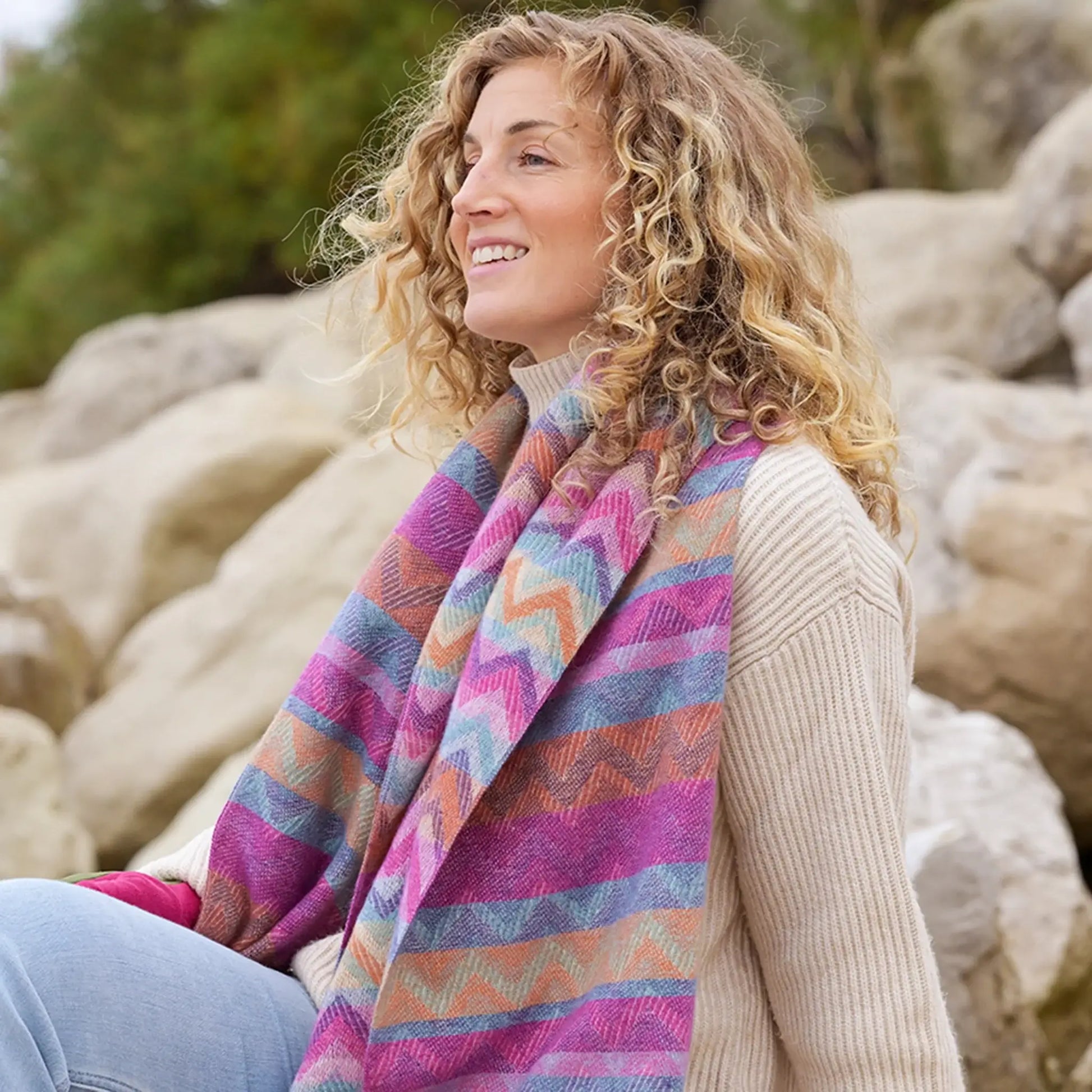 Model wearing chevron stripe scarf in pink and ochre with fringe 