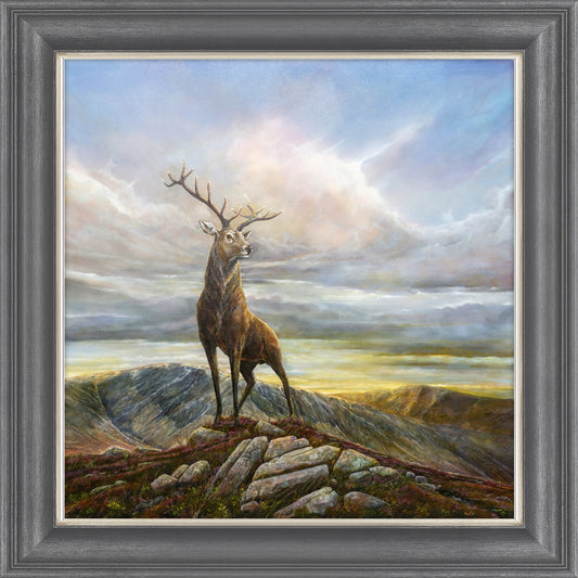 A framed print of a painting of a stag 