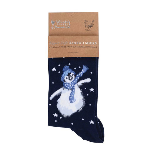 Folded pair of Christmas socks in navy with a penguin in hat and scarf